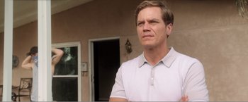 Movie still from “99 Homes” (2014), directed by Ramin Bahrani – A person wearing a polo shirt; Close Up shot, Low angle