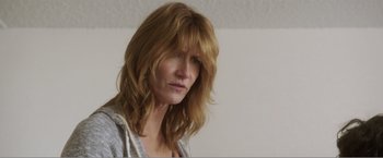 Movie still from “99 Homes” (2014), directed by Ramin Bahrani – A person with long red hair; Close Up shot, Low angle