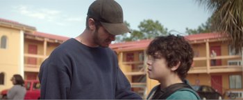 Movie still from “99 Homes” (2014), directed by Ramin Bahrani – A man and a boy talking to each other; Close Up shot, Over the shoulder angle