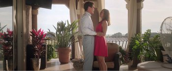Movie still from “99 Homes” (2014), directed by Ramin Bahrani – A man and a woman standing next to each other on a porch; Medium shot, Low angle