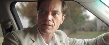 Movie still from “99 Homes” (2014), directed by Ramin Bahrani – A person in a car; Close Up shot, Over the shoulder angle