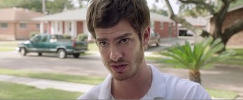 Movie still from “99 Homes” (2014), directed by Ramin Bahrani – A person wearing a white shirt; Close Up shot, Over the shoulder angle