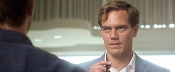 Movie still from “99 Homes” (2014), directed by Ramin Bahrani – A man that is putting on a tie; Close Up shot, Over the shoulder angle
