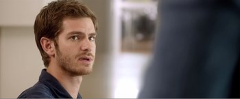 Movie still from “99 Homes” (2014), directed by Ramin Bahrani – A person with a beard; Close Up shot, Over the shoulder angle