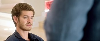 Movie still from “99 Homes” (2014), directed by Ramin Bahrani – A person sitting in front of a camera; Close Up shot, Over the shoulder angle