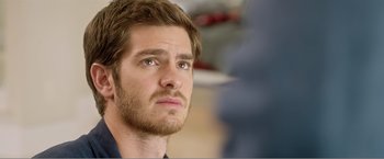 Movie still from “99 Homes” (2014), directed by Ramin Bahrani – A person with a beard; Close Up shot, Over the shoulder angle