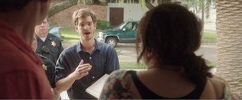 Movie still from “99 Homes” (2014), directed by Ramin Bahrani – A man talking to a woman in front of a house; Medium shot, Over the shoulder angle