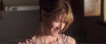 Movie still from “99 Homes” (2014), directed by Ramin Bahrani – A woman's face in the sunlight; Close Up shot, Over the shoulder angle