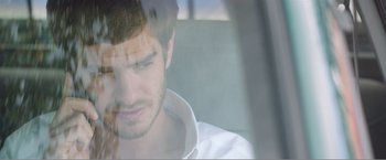 Movie still from “99 Homes” (2014), directed by Ramin Bahrani – A man sitting in the back seat of a car; Close Up shot, Over the shoulder angle