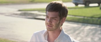 Movie still from “99 Homes” (2014), directed by Ramin Bahrani – A person wearing a white shirt; Close Up shot, Over the shoulder angle
