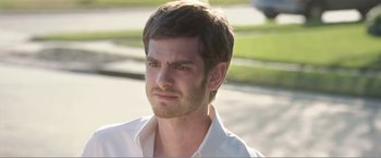 Movie still from “99 Homes” (2014), directed by Ramin Bahrani – A person wearing a white shirt; Close Up shot, Over the shoulder angle