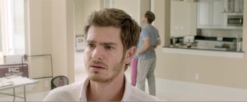Movie still from “99 Homes” (2014), directed by Ramin Bahrani – A man with a concerned look on his face; Close Up shot, Over the shoulder angle