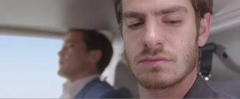 Movie still from “99 Homes” (2014), directed by Ramin Bahrani – A man with his eyes closed; Close Up shot, Over the shoulder angle