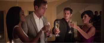 Movie still from “99 Homes” (2014), directed by Ramin Bahrani – Two men are drinking champagne from champagne flutes; Medium shot, Over the shoulder angle