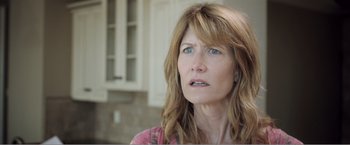 Movie still from “99 Homes” (2014), directed by Ramin Bahrani – A person with long brown hair; Close Up shot, Low angle