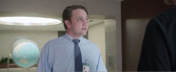 Movie still from “99 Homes” (2014), directed by Ramin Bahrani – A man wearing a blue dress shirt and a tie; Close Up shot, Low angle