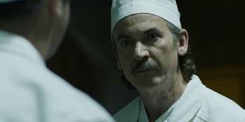 Movie still from “Chernobyl” (2019), directed by Johan Renck – A person wearing a hat; Close Up shot, Over the shoulder angle