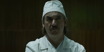 Movie still from “Chernobyl” (2019), directed by Johan Renck – A person wearing a hat; Close Up shot, Low angle