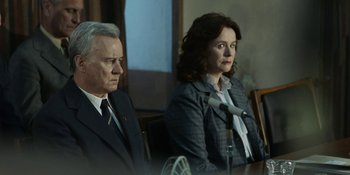 Movie still from “Chernobyl” (2019), directed by Johan Renck – A man and a woman sitting in front of microphones; Medium shot, Over the shoulder angle