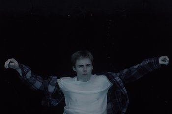 Movie still from “The Kid Laroi - Bleed” (2023), directed by Ramez Silyan – Medium shot, Overhead angle