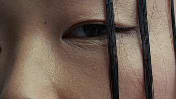 Movie still from “Audrey Nuna - Locket” (2023), directed by Valentin Petit – Extreme Close Up shot, Overhead angle