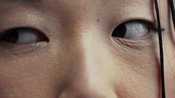 Movie still from “Audrey Nuna - Locket” (2023), directed by Valentin Petit – Extreme Close Up shot, High angle