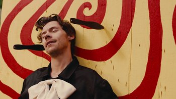 Movie still from “Harry Styles - Daylight” (2023), directed by Tanu Muiño – Close Up shot, High angle