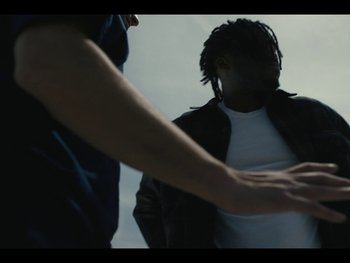Movie still from “Mick Jenkins - Smoke Break-Dance” (2023), directed by Andre Muir – Medium shot, Low angle