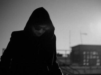 Movie still from “Depeche Mode - Ghosts Again” (2023), directed by Anton Corbijn – Medium shot, Low angle