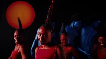 Movie still from “Tshegue - Mais” (2022), directed by Ibrahim Kamara – Medium shot, Low angle