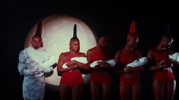 Movie still from “Tshegue - Mais” (2022), directed by Ibrahim Kamara – Medium shot, Low angle
