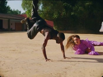 Movie still from “Elton John, Britney Spears - Hold Me Closer” (2022), directed by Tanu Muiño – Wide shot, Low angle