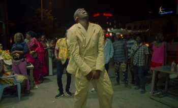 Movie still from “Oko Ebombo - Nalingi Yo” (2022), directed by Frank Lebon – Medium shot, Low angle