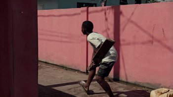 Movie still from “Loyle Carner - Georgetown” (2022), directed by Machine Operated – Wide shot, Low angle