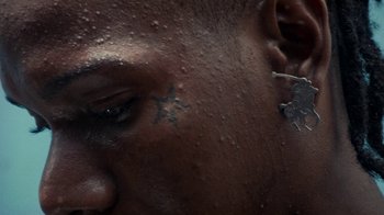 Movie still from “Loyle Carner - Georgetown” (2022), directed by Machine Operated – Extreme Close Up shot, Overhead angle