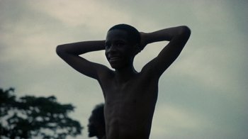 Movie still from “Loyle Carner - Georgetown” (2022), directed by Machine Operated – Medium shot, Low angle