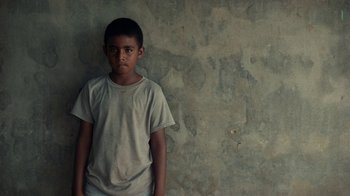 Movie still from “Loyle Carner - Georgetown” (2022), directed by Machine Operated – Close Up shot, Low angle