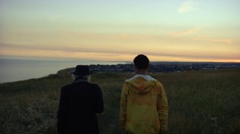 Movie still from “Loyle Carner - Georgetown” (2022), directed by Machine Operated – Medium shot, Over the shoulder angle