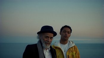 Movie still from “Loyle Carner - Georgetown” (2022), directed by Machine Operated – Medium shot, Low angle