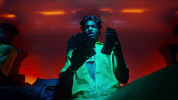 Movie still from “Pharrell - Cash In Cash Out” (2022), directed by François Rousselet – Medium shot, Low angle