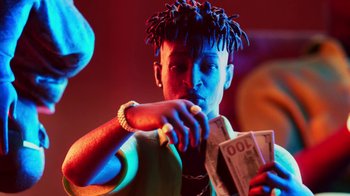 Movie still from “Pharrell - Cash In Cash Out” (2022), directed by François Rousselet – Medium shot, Low angle