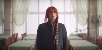Movie still from “Florence + The Machine - Free” (2022), directed by Autumn de Wilde – Medium shot, Low angle
