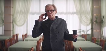 Movie still from “Florence + The Machine - Free” (2022), directed by Autumn de Wilde – Medium shot, Low angle