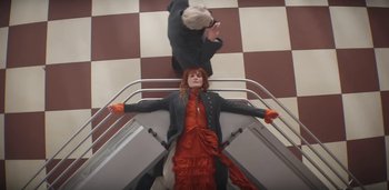 Movie still from “Florence + The Machine - Free” (2022), directed by Autumn de Wilde – Medium shot, Overhead angle