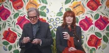 Movie still from “Florence + The Machine - Free” (2022), directed by Autumn de Wilde – Medium shot, Low angle