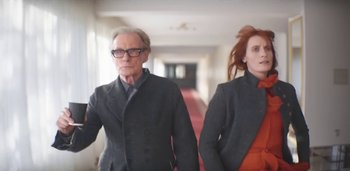 Movie still from “Florence + The Machine - Free” (2022), directed by Autumn de Wilde – Medium shot, Low angle