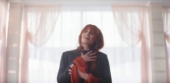 Movie still from “Florence + The Machine - Free” (2022), directed by Autumn de Wilde – Medium shot, Low angle