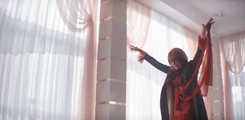 Movie still from “Florence + The Machine - Free” (2022), directed by Autumn de Wilde – Medium shot, Low angle