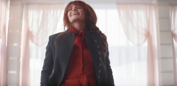 Movie still from “Florence + The Machine - Free” (2022), directed by Autumn de Wilde – Medium shot, Low angle
