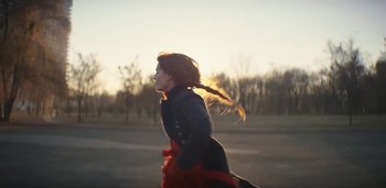 Movie still from “Florence + The Machine - Free” (2022), directed by Autumn de Wilde – Medium shot, Low angle